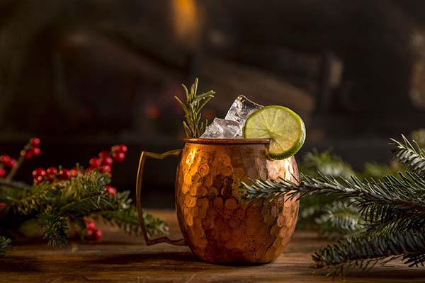 A festive holiday drink in a moscow mule cup by the fire at Antica Pesa in Brooklyn.