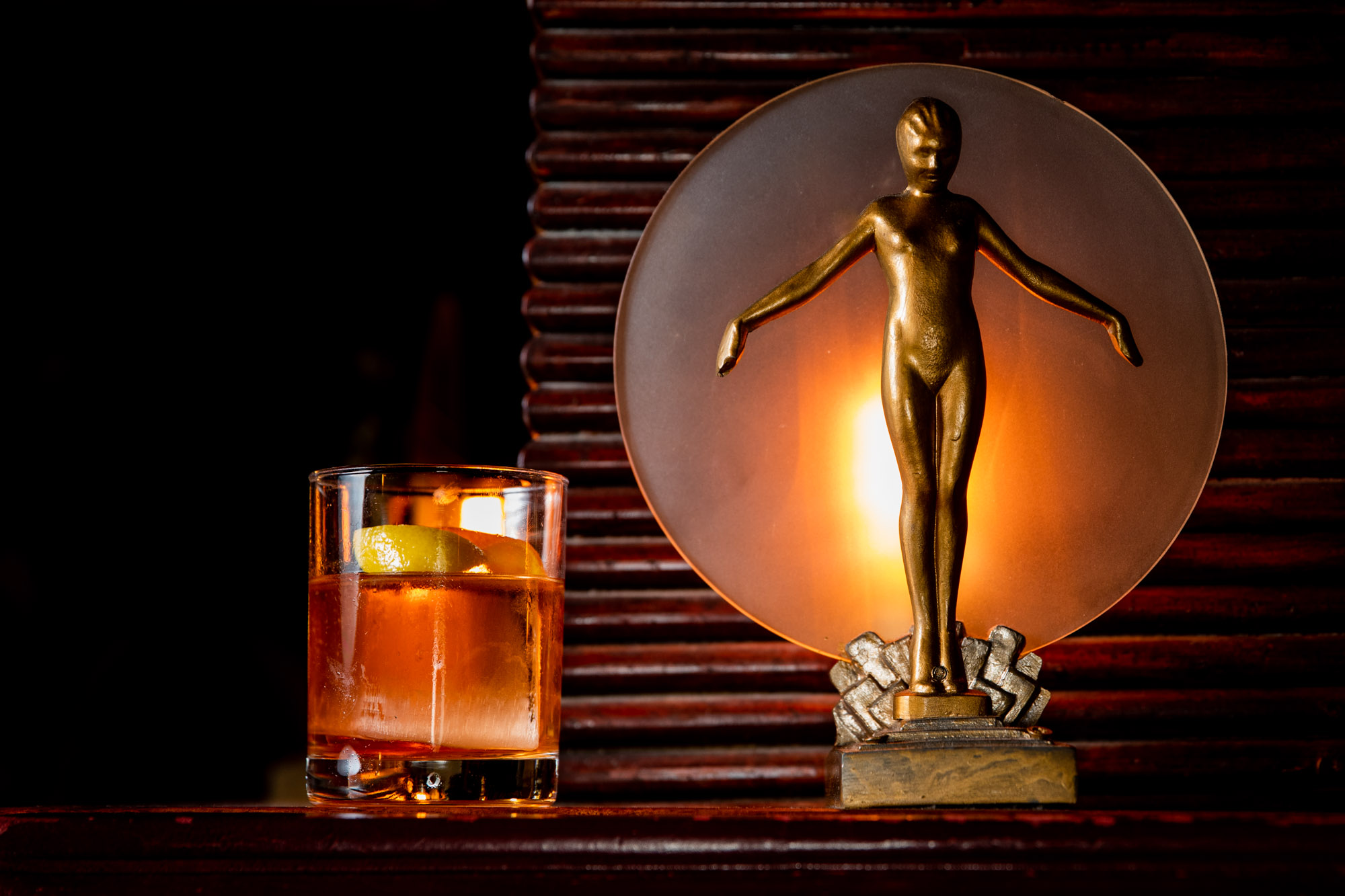 a drink next to a copper statue