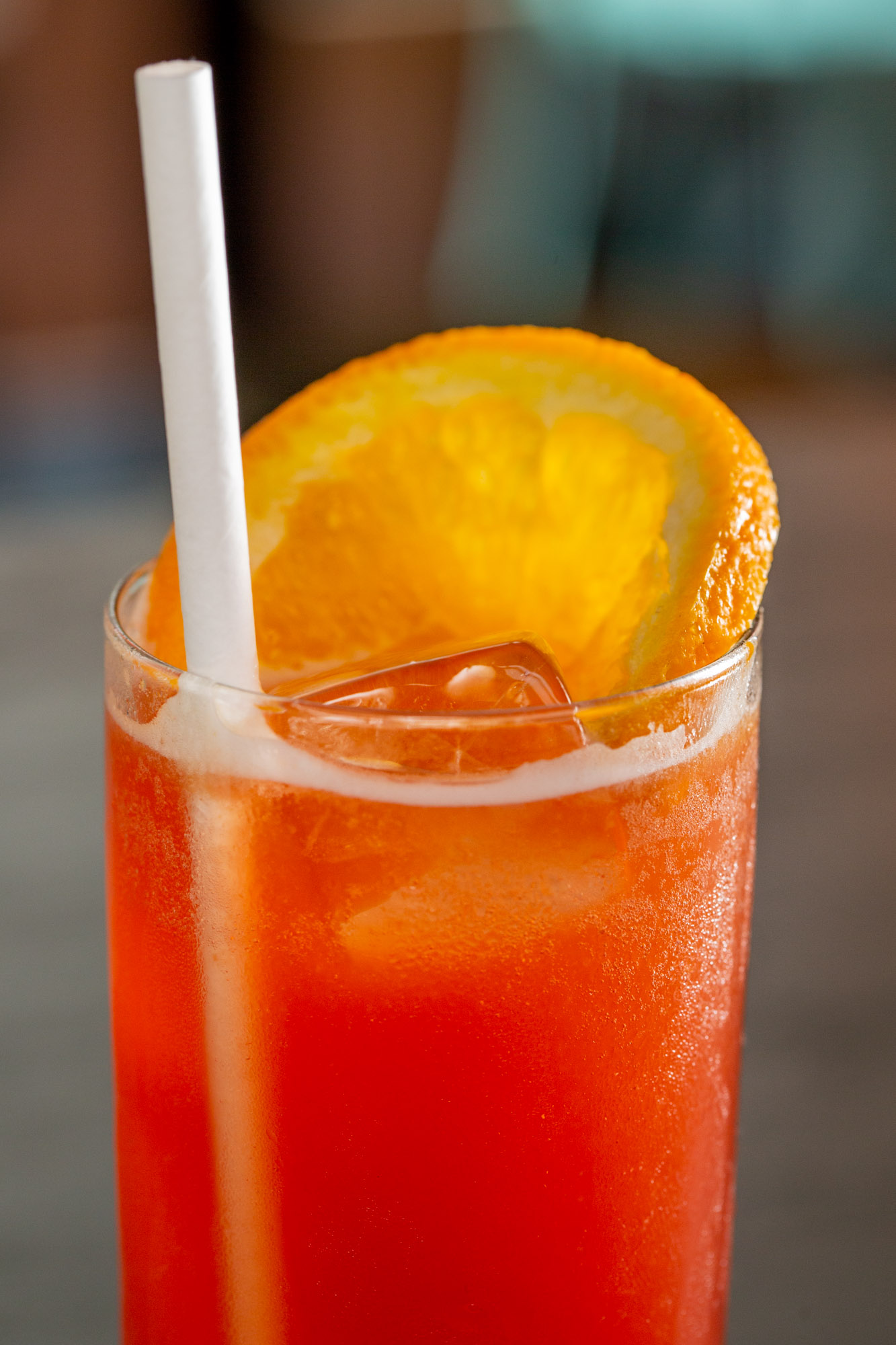closeup of an orange garnished alcoholic drink