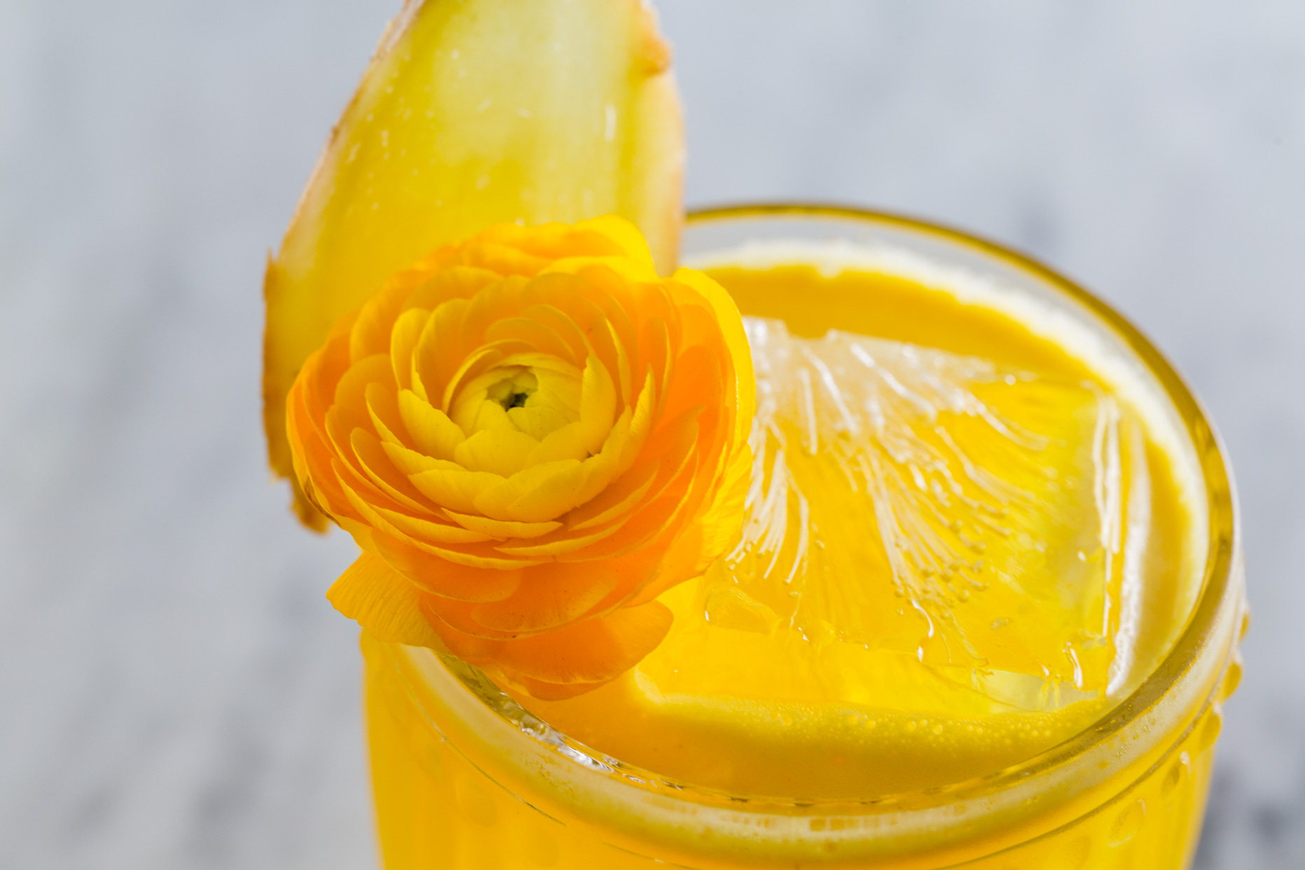 Yellow drink with a yellow flower adorning it